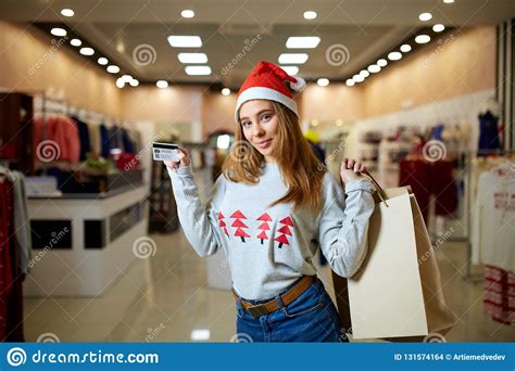 When you open a retail credit card account, you make purchases from the store that. Happy Young Blonde Woman In Christmas Hat Holding Credit Card And Colorful Shopping Bags ...