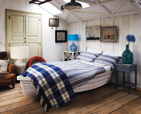 Cottage style primary bedroom with hardwood floors, white walls and a white ceiling. How to create a coastal style bedroom | | Cosy Home Blog