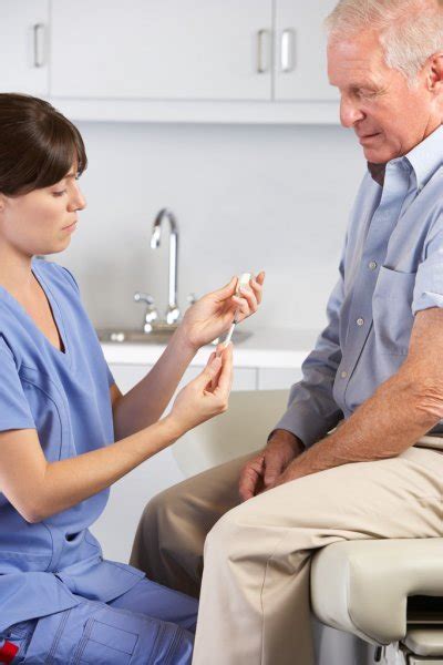Doctor Examining Male Patient With Hip Pain Stock Photo By