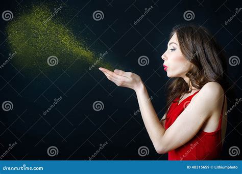 Young Woman Blowing At Golden Dust In Her Hands Stock Image Image Of