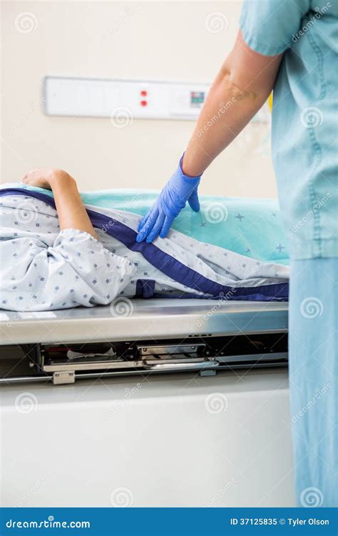 Nurse Standing By Patient Lying On Xray Table Stock Image Image Of