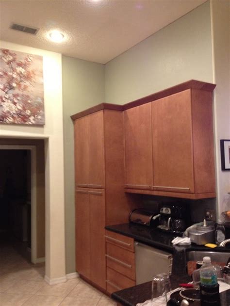 The microwave has an exhaust hood underneath it for. What to put above kitchen cabinets in a TALL kitchen?