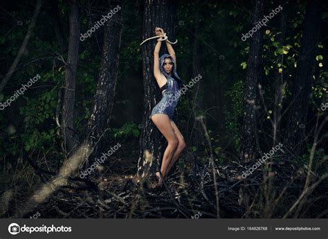 A Girl Tied To A Tree In A Forest Dark Forest Esoterics Stock Photo