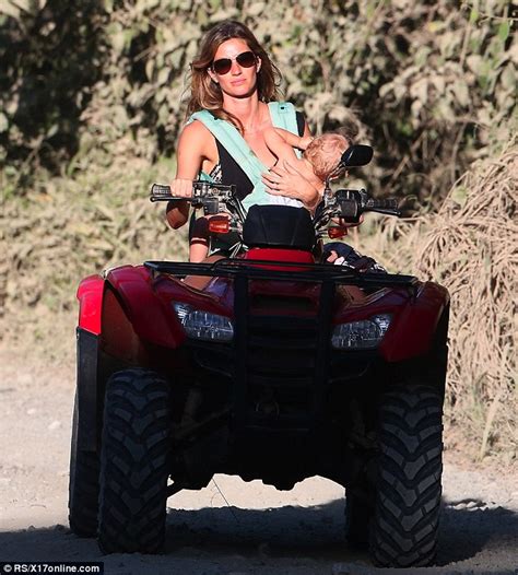 Gisele B Ndchen Carries Her Baby In One Arm As She Rides A Quad Bike On