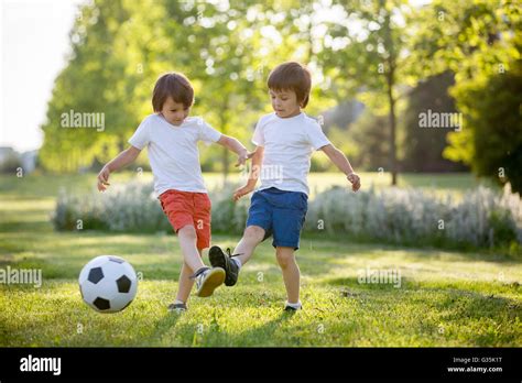 Two Cute Little Kids Playing Football Together Summertime Children