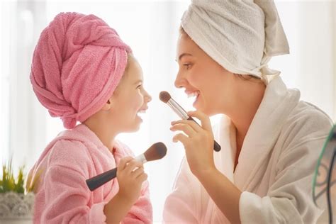 premium photo mother and daughter are doing make up