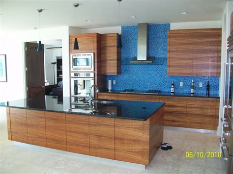 Resurfacing kitchen cabinets means that you retain your original cabinet boxes and existing cabinet layout and simply remove and replace the front layer of your cabinet doors. Water Front Home Koa Kitchen - Kitchen - Orlando - by Beach Cabinets, LLC