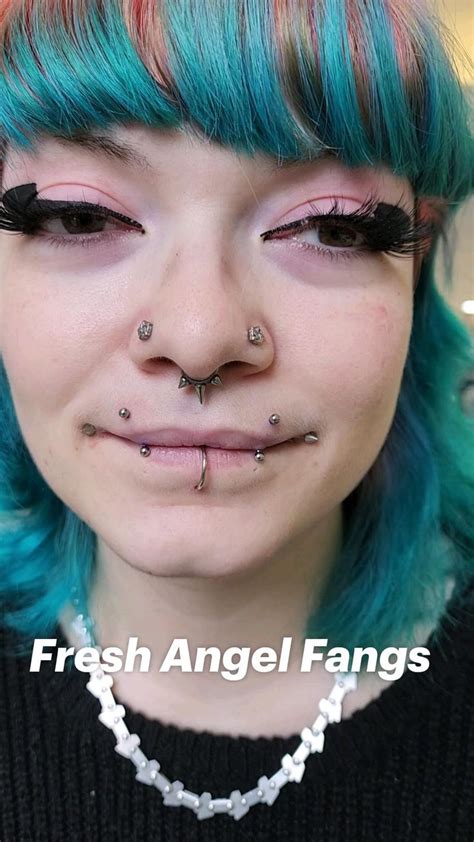 Fresh Angel Fangs And Healed Paired Nostrils And Dahlias In