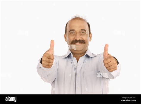 Portrait Of A Man Showing Thumbs Up And Smiling Stock Photo Alamy