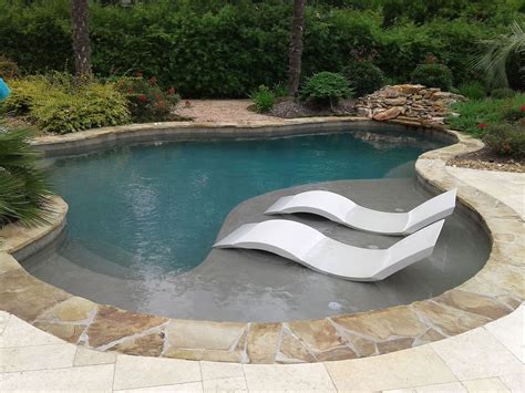 Freeform Pool With Tanning Ledge Ledge Loungers Rock Waterfall Cocktail Table With Umbrella