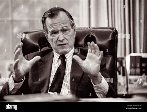 President George Hw Bush At His Desk In The Oval Office Of The White