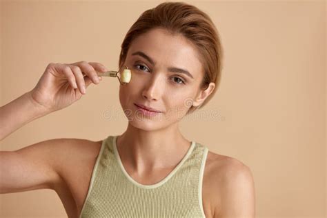 Face Massage Smiling Woman Using Jade Facial Roller For Skin Care Stock Image Image Of Model