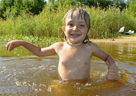 Little Girl In Water On Sunny Day ⬇ Stock Photo Image By © Surzet