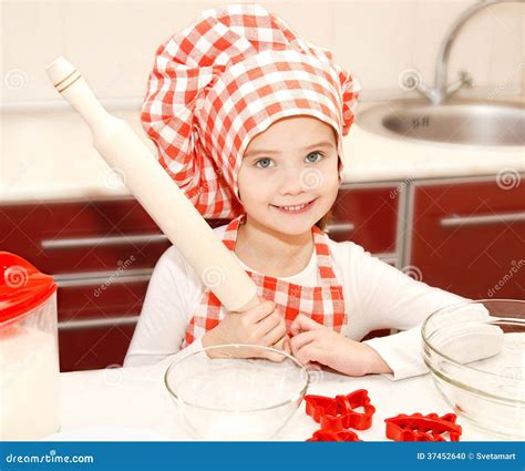 Little Girl With Chef Hat And Rolling Pin Is Going To Bake Cookies