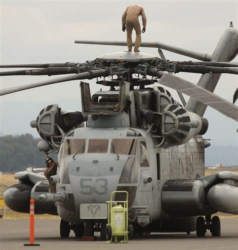 Us Marine Corps Engineer Standing On The Rotor Head Of A Ch 53e Super