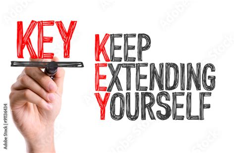 Hand With Marker Writing The Word Keep Extending Yourself Stock Photo