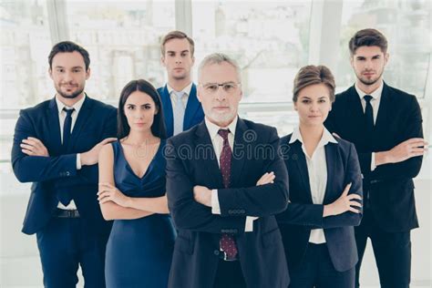 Group Of Six Confident Serious Business People Standing Together Stock