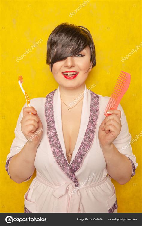 Cute Chubby Girl Pink Robe Stands Comb Toothbrush Yellow Background