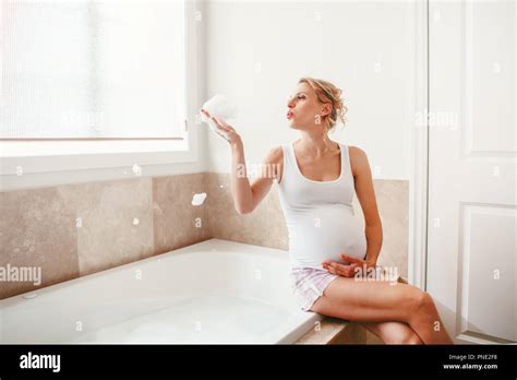 Portrait Of Pregnant Blonde Caucasian Woman In Bathroom In The Morning