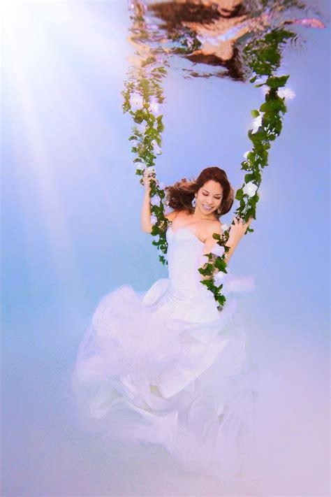 Leng yuting, 26, posing underwater for her wedding pictures at a photo studio in shanghai, ahead of her. Underwater Bride swinging on floral vine by Adam Opris ...