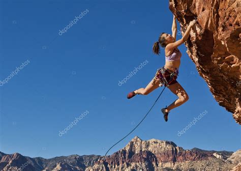 Female Rock Climber Clinging To A Cliff — Stock Photo © Gregepperson