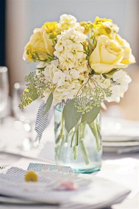 Pretty Centerpiece With Pale Yellow Flowers In A Mason Jarthis Is
