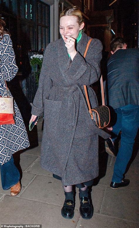 Elle Fanning Wraps Up Warm In A Long Grey Winter Coat As She Enjoys A Night Out In Soho With