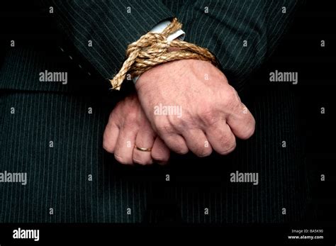 A Horizontal View Of A Business Man With His Hands Tied Infront Of Him