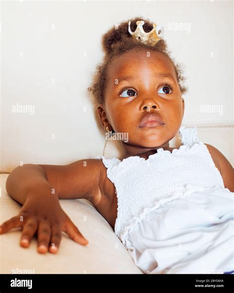 little cute african american girl playing at home pretty adorable princess in interior happy