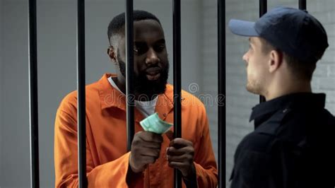 African American Prisoner Giving Euro Cash To Guard Corruption In Jail