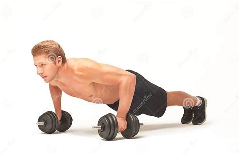 Muscular Shirtless Sportsman Doing Push Ups With Dumbbells On White