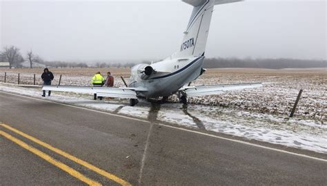 Plane slides on snowy runway, across Ind. 227