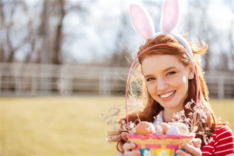 premium photo portrait of a happy red head girl wearing bunny ears