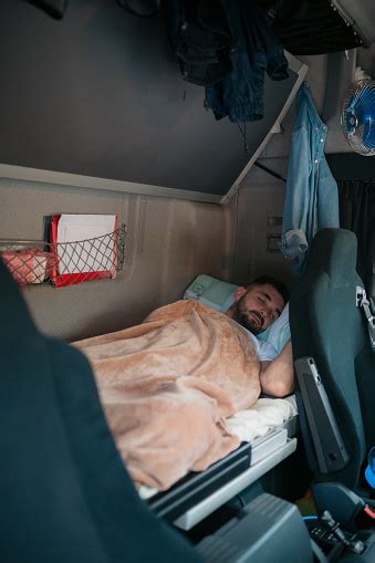 Trucker Sleeping In The Trucks Sleeping Cabin Stock Photo Download