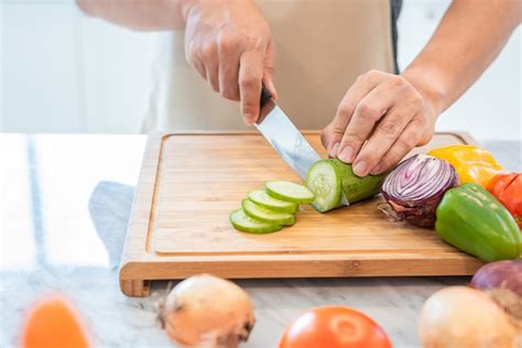 Premium Photo Close Up Of Man Hand Cooking And Slicing Vegetable In