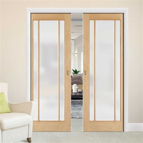 The large glass panels in these internal double doors allow natural light to flow between. Lincoln Glazed Oak Double Evokit Pocket Doors - Frosted Glass