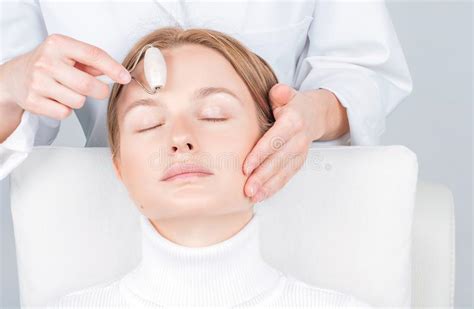 Beautiful Woman Having Face Treatment Cosmetologist Massaging Forehead