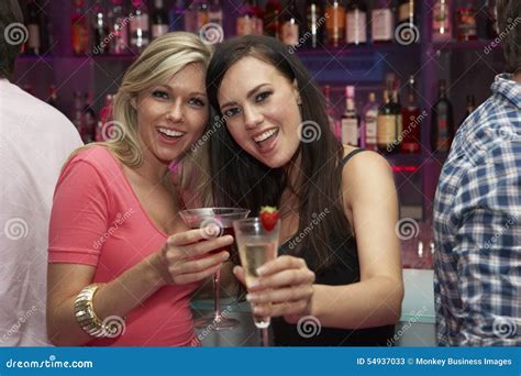 Two Young Women Enjoying Drinks In Bar Stock Image Image Of Friends