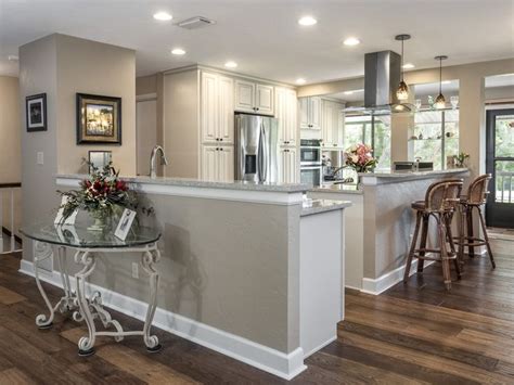 Thertastore.com is the largest online dealer of rta and diy kitchen cabinets and bathroom cabinets! Open Kitchen in cream colored cabinets, wood floors, stainless steel appliances, light tan/brow ...