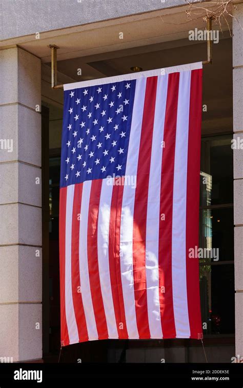 A Large American Flag Hanging Vertically In Washington Dc Stock Photo