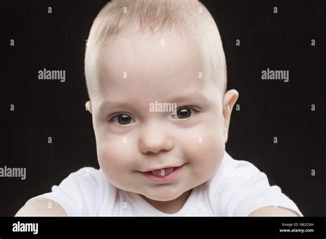 Portrait Of Smiling Baby Boy Against Black Background Stock Photo Alamy