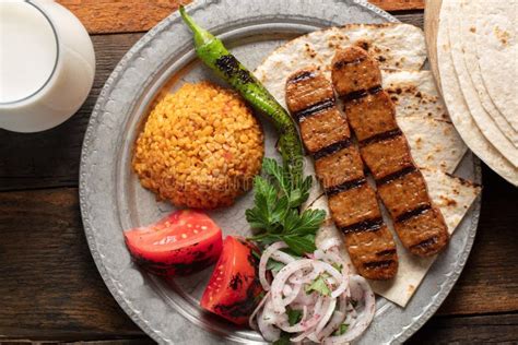 Turkish Adana Kebap With Rice Pilaf And Vegetables Served On A Plate