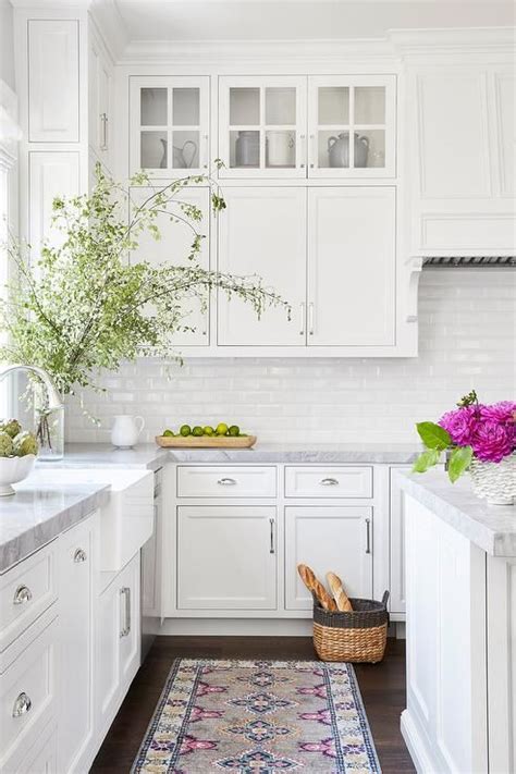 Complete the look with a cool grey backsplash and gorgeous waterproof plank. A pink and gray vintage rug sits in front of a farmhouse ...