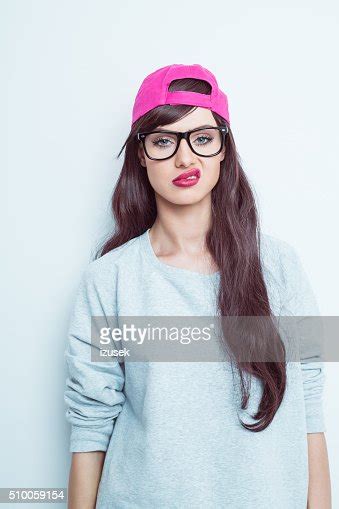 Disappointed Young Woman Wearing Nerd Glasses And Pink Baseball Cap