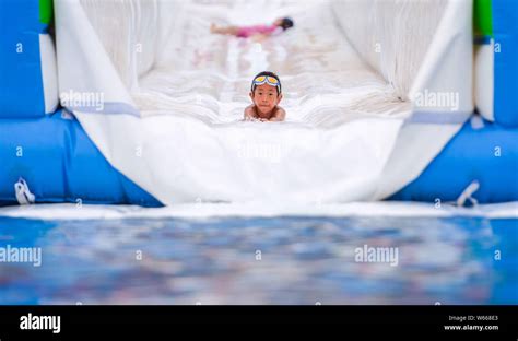A Tourist Plays On Asias Longest Water Slide At Jingzhihu Resort In