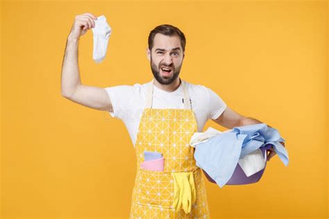 Disgusted Young Man Househusband In Apron Hold Basket With Clean