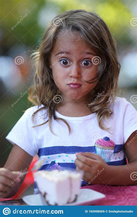 Portrait Of A Beautiful 4 Year Old Girl Who Makes Funny Faces Stock