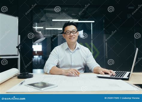 Portrait Of Successful Asian Male Architect Smiling And Looking At