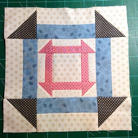 A Piece Of Quilted Material With An Arrow On It