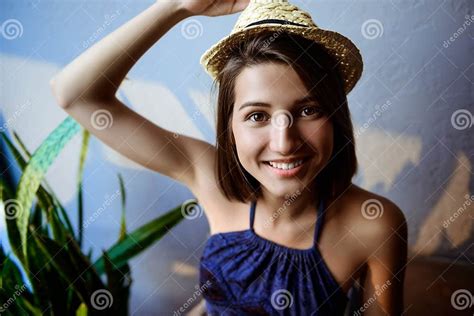 Young Beautiful Brunette Girl In Hat Sitting On Stairs Smiling Stock